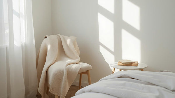 Beautiful Pearl white bedsheet on the bed with a chair having a white throw