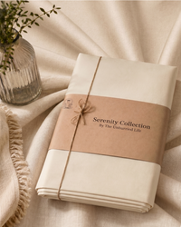 Packaged product from the Serenity Collection by The Unhurried Life on a soft cream beige fabric background.