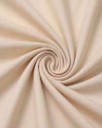 Close-up of cream beige fabric with a swirl pattern