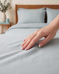 Finger lingers on a sILVER grey bedsheet