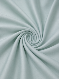 Close-up of light blue fabric with a swirl pattern