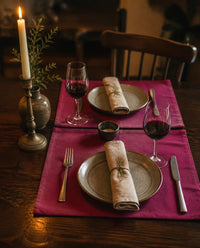 Mulberry pink table mats set for a candlelit dinner for two - The Unhurried Life