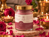 Rose Foot Soak, 80 g, in a glass jar with a gold lid and a plum and cream label, surrounded by red roses, rose petals and glowing brass bowls.
